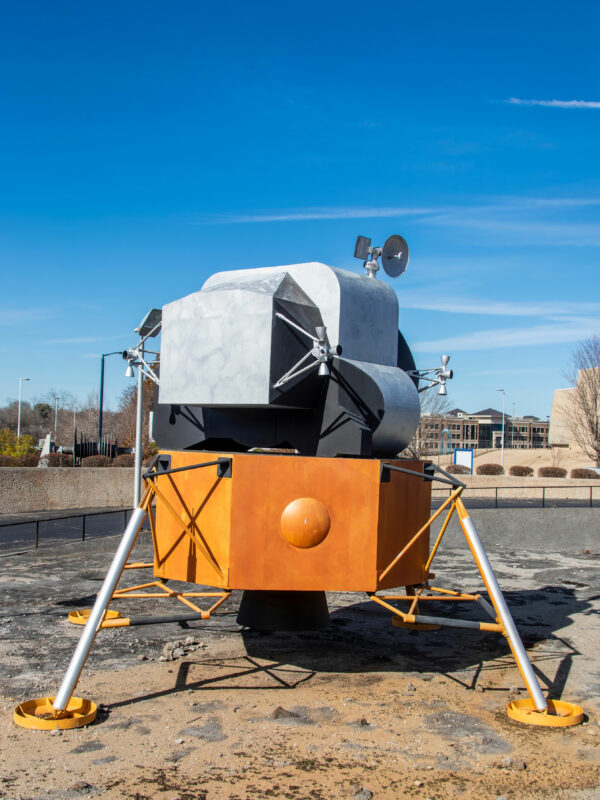 Students exploring a lunar landing module on a space camp