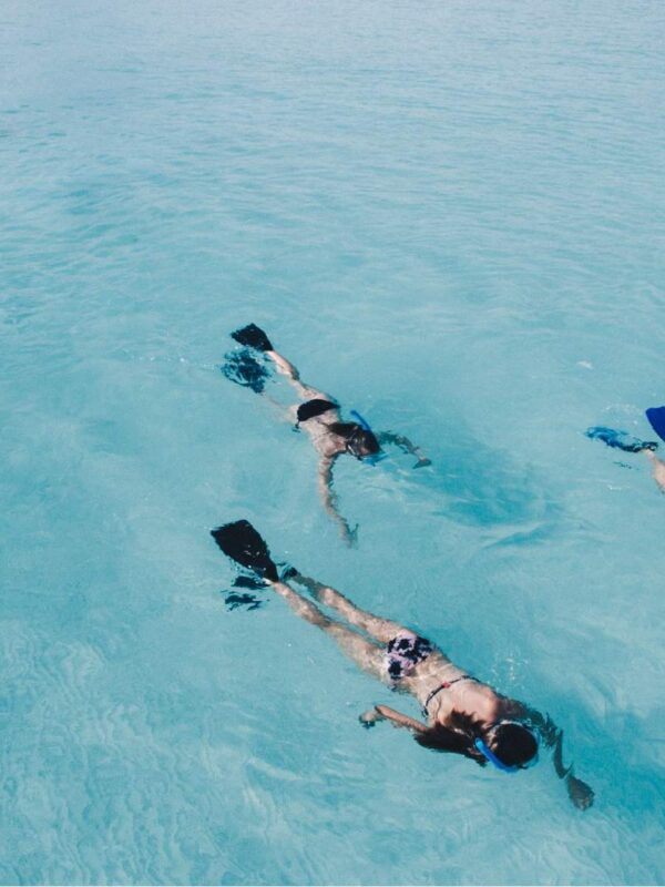 3 girls snorkling in clear blue water