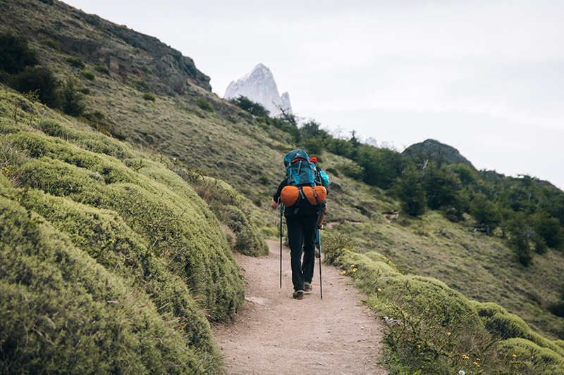 Backpackers hiking up a mountain