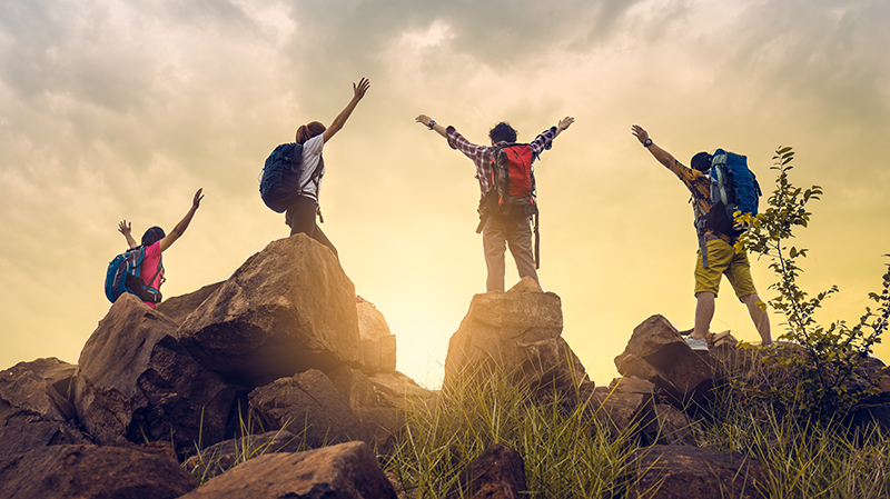 A group of students navigating a difficult trail, showing teamwork and leadership in action
