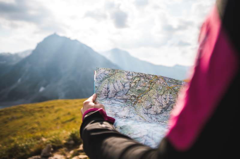 Hiker navigating on a school expedition with a map
